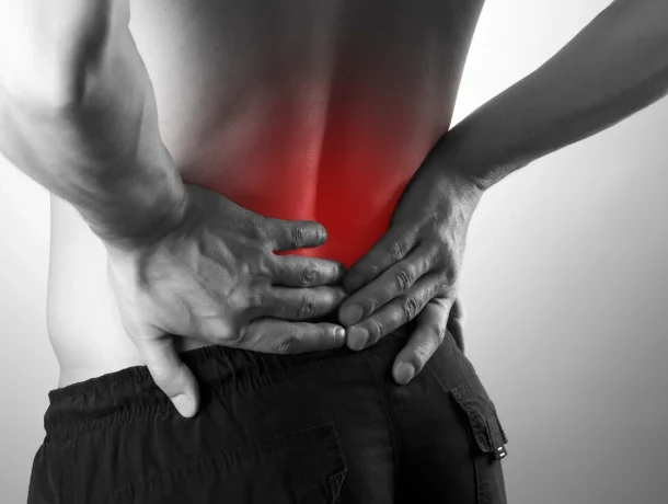 Man holding back suffering from back pain