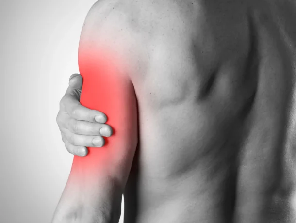 Man with muscle pain holding arm