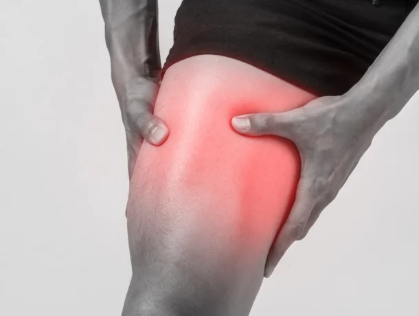 Man with muscle pain holding thigh